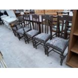 FOUR STAINED OAK DINING CHAIRS AND AN OAK ARMCHAIR