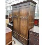 AN EARLY 20TH CENTURY OAK TWO DOOR WARDROBE WITH TWO DRAWERS TO BASE, 52" WIDE