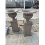 A PAIR OF DECORATIVE PLASTIC GARDEN PLANTERS ON A PEDASTEL BASE