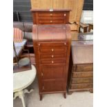 A REPRODUCTION TALL CHEST WITH FIVE DRAWERS, TWO CUPBOARDS AND CYLINDER ACTION TO THE UPPER