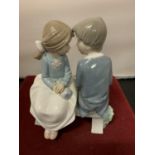 A NAO FIGURINE OF A BOY AND GIRL ON A BENCH