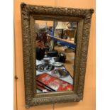 A DECORATIVE GILT FRAMED PORTRAIT ORIENTATED MIRROR (67X55CM)