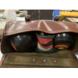 A PAIR OF BOWLING BOWLS IN A CARRYING CASE