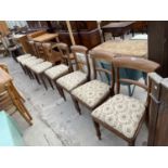 A SET OF EIGHT VICTORIAN MAHOGANY YOKE BACK DINING CHAIRS ON TURNED FRONT LEGS