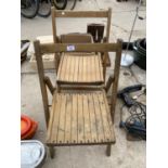 A PAIR OF WOODEN FOLDING CHAIRS