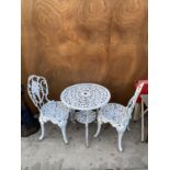 A WHITE METAL BISTRO TABLE WITH TWO CHAIRS