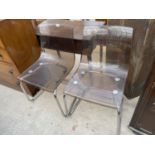 A PAIR OF RETRO CLEAR MOULDED PLASTIC DINING CHAIRS ON CHROME TUBULAR BASES