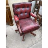 A REPRODUX OXBLOOD SWIVEL OFFICE CHAIR WITH BUTTON BACK
