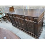 AN EARLY 20TH CENTURY JACOBEAN STYLE SIDEBOARD ENCLOSING THREE FRIEZE DRAWERS AND THREE CARVED PANEL