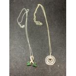 TWO SILVER NECKLACES TO INCLUDE GREEN AND CLEAR STONE TWIST AND CIRCULAR CLEAR STONE PENDANTS