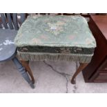 AN UPHOLSTERED DRESSING STOOL ON CABRIOLE SUPPORTS