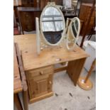 A PINE SINGLE PEDESTAL DRESSING TABLE AND CREAM/GILT TRIPLE MIRROR