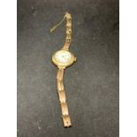 A LADIES 9 CARAT GOLD WATCH WITH CIRCULAR FACE A/F