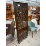 AN OAK PRIORY CORNER CABINET WITH GLAZED AND LEADED UPPER PORTION, 26" WIDE