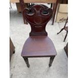 A REGENCY MAHOGANY HALL CHAIR WITH URN SHAPED BACK, ONTURNED AND FLUTED FRONT LEGS