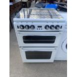 A WHITE AND CHROME HANDLED NEW WORLD GAS AND ELECTRIC FREE STANDING COOKER