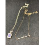 TWO NECKLACES TO INCLUDE A SILVER WITH PURPLE AND CLEAR STONE PENDANT AND A SILVER GILT WITH CLEAR