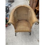 A WICKER CONSERVATORY ARMCHAIR ON IRONWORK FRAME