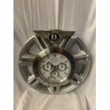 A DEALERS WALL CLOCK MOUNTED ON AN ORIGINAL 22" BENTLEY CONTINENTAL WHEEL (D: 59CM)