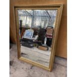 A RECTANGULAR GILT FRAMED BEVEL EDGE MIRROR