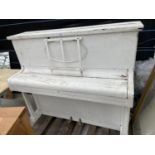 A WHITE PAINTED UPRIGHT PIANO