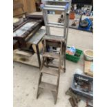 A VINTAGE FOUR RUNG WOODEN STEP KLADDER AND A FURTHER ALLUMINIUM LOFT LADDER