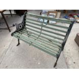 A WOODEN GARDEN BENCH WITH CAST IRON BENCH ENDS