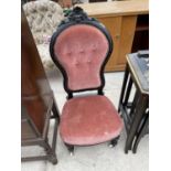 A VICTORIAN EBONISED NURSING CHAIR WITH BUTTON-BACK