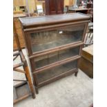 A GLOBE WERNICKE STYLE THREE TIER BOOKCASE, N.B. BACK OF TOP SECTION WORMY