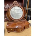 A VINTAGE DRESSING TABLE MIRROR INCLOSING THREE SMALL DRAWERS