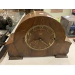 A WOODEN MANTEL CLOCK WITH BRASS DETAIL