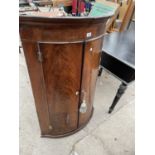 A GEORGE III MAHOGANY BOWFRONTED CORNER CUPBOARD