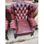 AN OXBLOOD WINGED CHAIR ON CABRIOLE LEGS