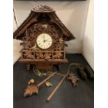 A VERY LARGE EXAMPLE OF A WOODEN HEAVILY CARVED CUCKOO CLOCK TO INCLUDE WEIGHTS (APPROXIMATELY