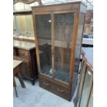 AN EARLY 20TH CENTURY OAK TWO DOOR DISPLAY CABINET WITH DRAWER BASE