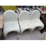 A SET OF THREE RETRO CREAMY COLOURED FIVE SHAPED STACKING CHAIRS