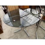 A CIRCULAR SMOKED GLASS TOP DINING TABLE ON CHROME TUBULAR BASE, 42" DIAMETER