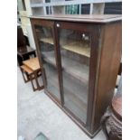 A VICTORIAN PINE TWO DOOR GLAZED BOOKCASE - 47" WIDE
