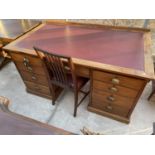 AN EARLY 20TH CENTURY MAHOGANY TWIN-PEDESTAL DESK ENCLOSING NINE DRAWERS, WITH BRASS SCOOP