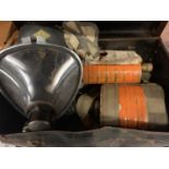 A VINTAGE GAS MASK WITH CANISTERS IN SMALL CASE