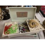 A DECORATED WOODEN BOX CONTAINING A LARGE SELECTION OF COSTUME JEWELLERY