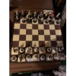 A CARVED WOODEN CHESS BOARD WITH PIECES