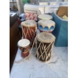 A QUANTITY OF TRIBAL DECORATED DRUMS AND BONGOS