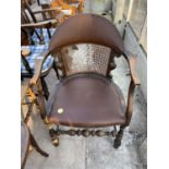 AN EARLY 20TH CENTURY JACOBEAN STYLE ELBOW CHAIR WITH SPLIT CANE BACK A/F