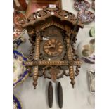 A VINTAGE GERMAN CARVED AND INLAID WOODEN CUCKOO CLOCK WITH TWO WEIGHTS
