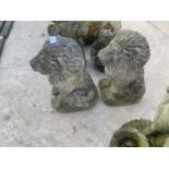 A PAIR OF STONE EFFECT SEATED LIONS