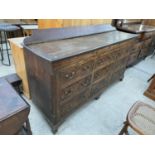 A GEORGE III OAK AND CROSSBANDED LANCASHIRE CHEST ENCLOSING SIX DRAWERS AND THREE SHAM DRAWERS,