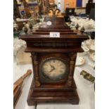 A ORNATE REPRODUCTION WOODEN MANTLE CLOCK WITH FOUR FINIALS (BATTERY OPERATED) 52CMS