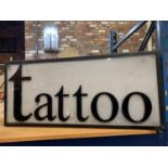 A LARGE ILLUMINATED 'TATTOO' SIGN