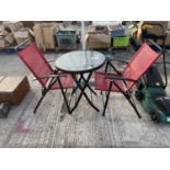 A BISTRO SET WITH METAL FRAME AND GLASS TOPPED TABLE AND TWO CHAIRS